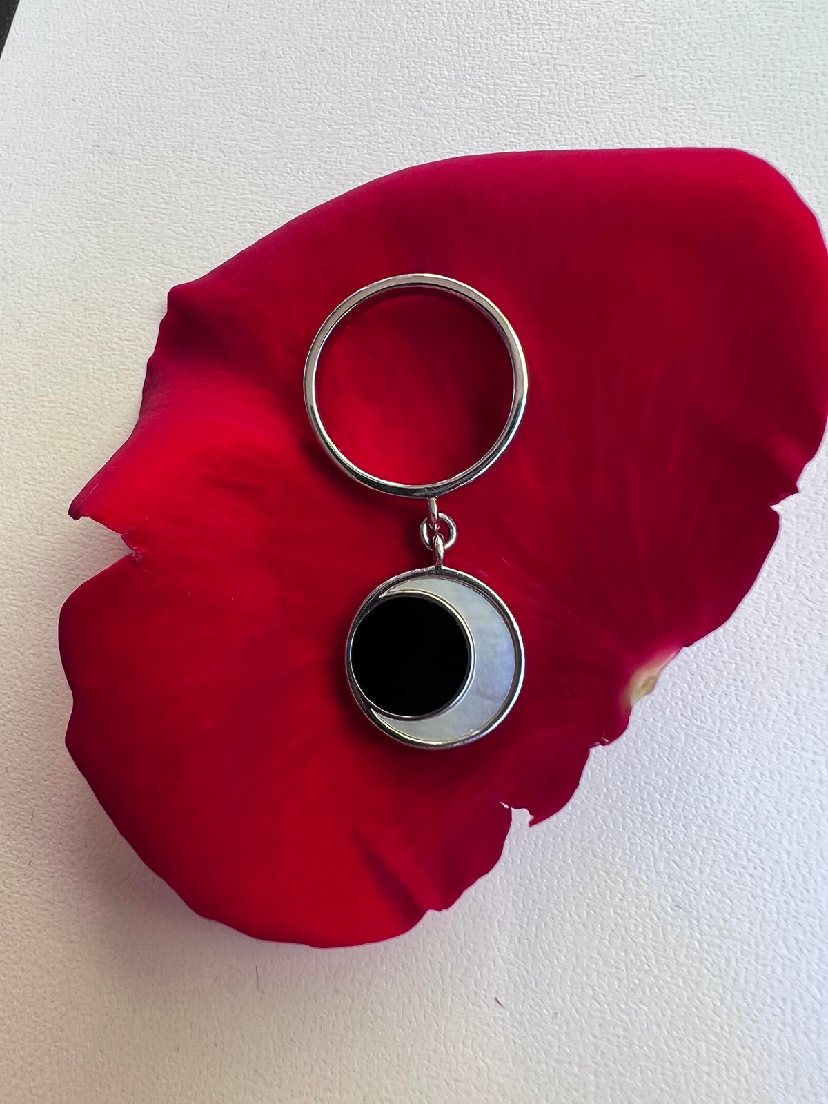 Eclipse Ring on rose petal
